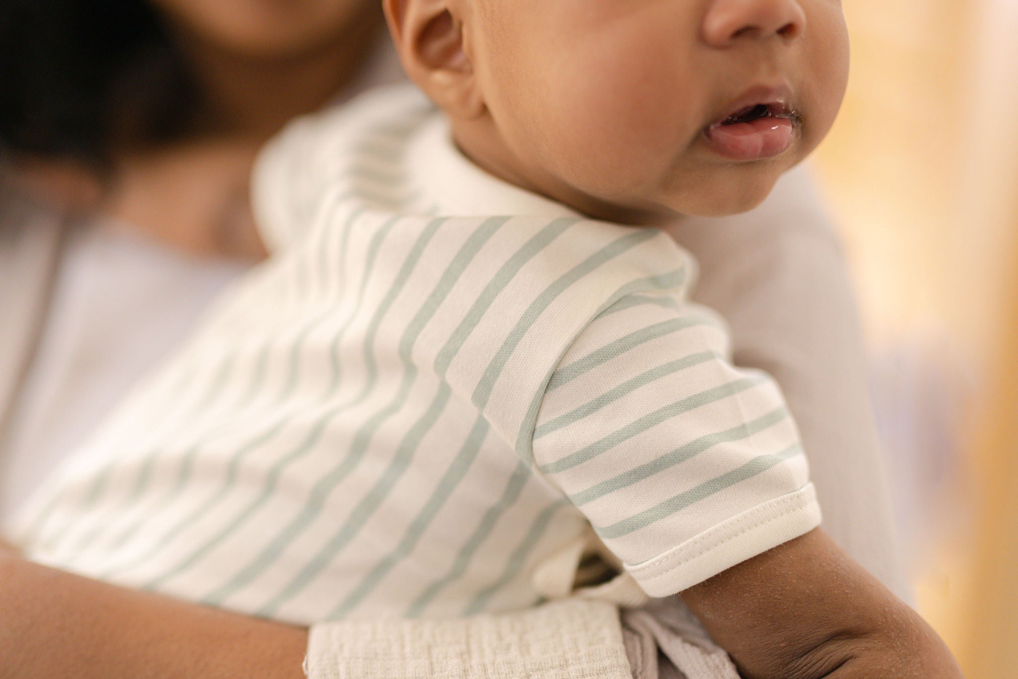 Mom holding baby over her shoulder