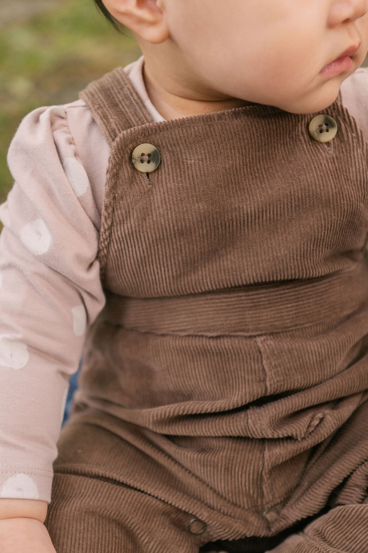 corduroy overall portobello in neutrals pattern up close on model with buttons