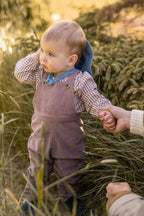 corduroy overall thistle in pinks pattern on baby