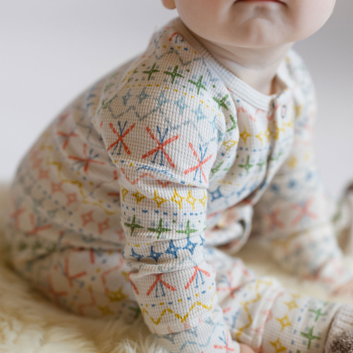 Petit Ski Raglan Romper - Snow Patrol- On Baby- Up Close Sleeve- Colorful Print