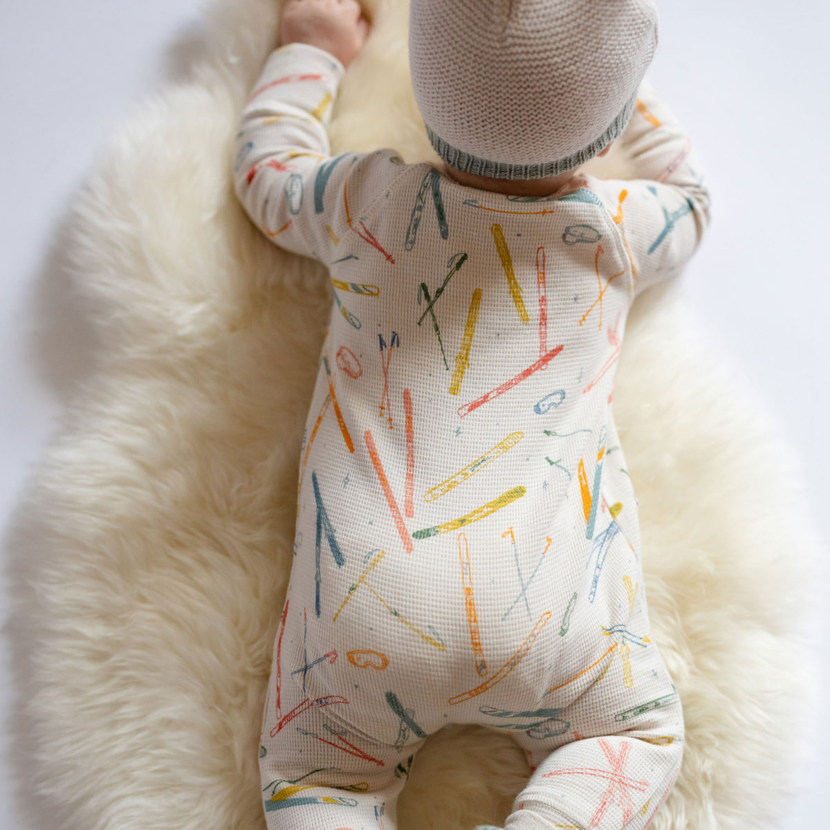 Petit Ski Raglan Romper - Apres- Long Sleeve and Legs- Back of  Baby- White with Colorful Ski Print