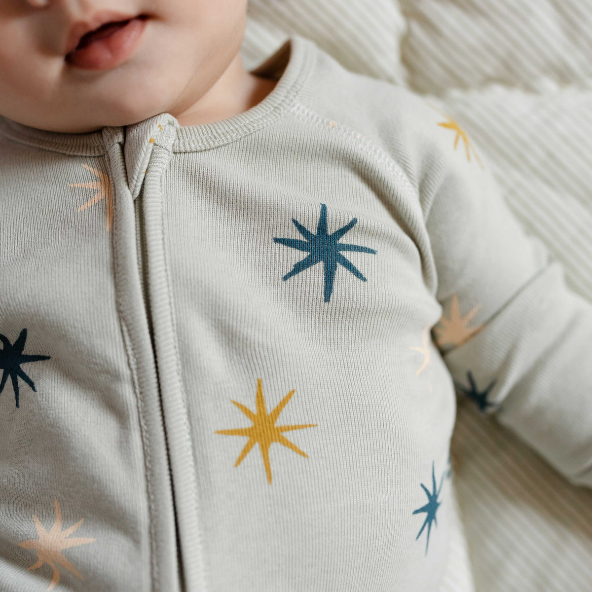 Ribbed Baby Sleeper - North Star- Up Close On Baby- Green With Star Print