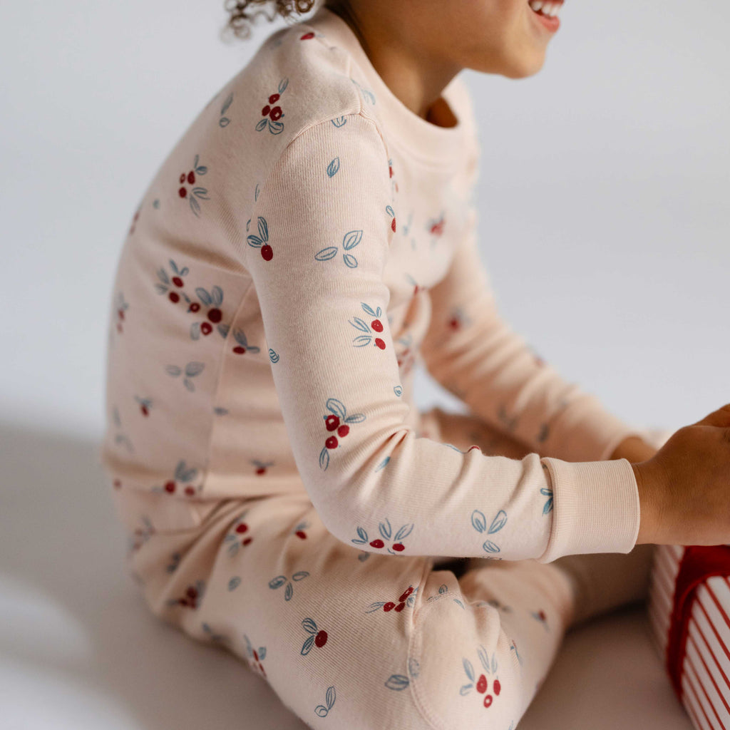 Ribbed Toddler Pajama - Berry Lane- Side of Child With Present- Holiday Print-Pink With Berries