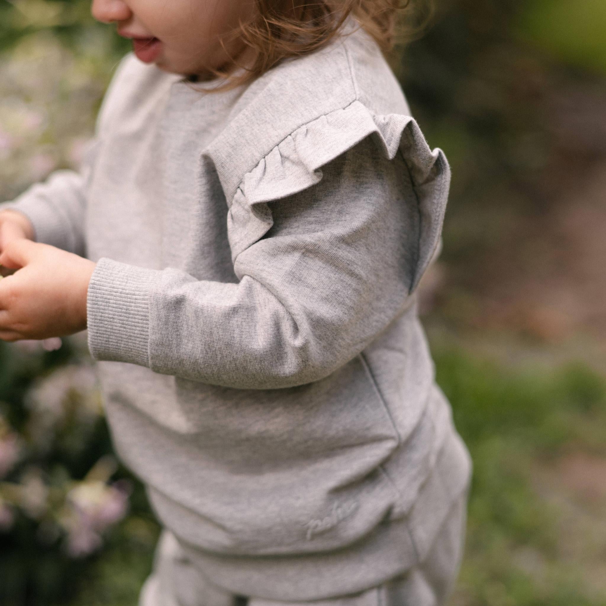 French Terry Toddler Ruffle Sweatshirt - Heather Grey- Side- Up Close Ruffle - On Model