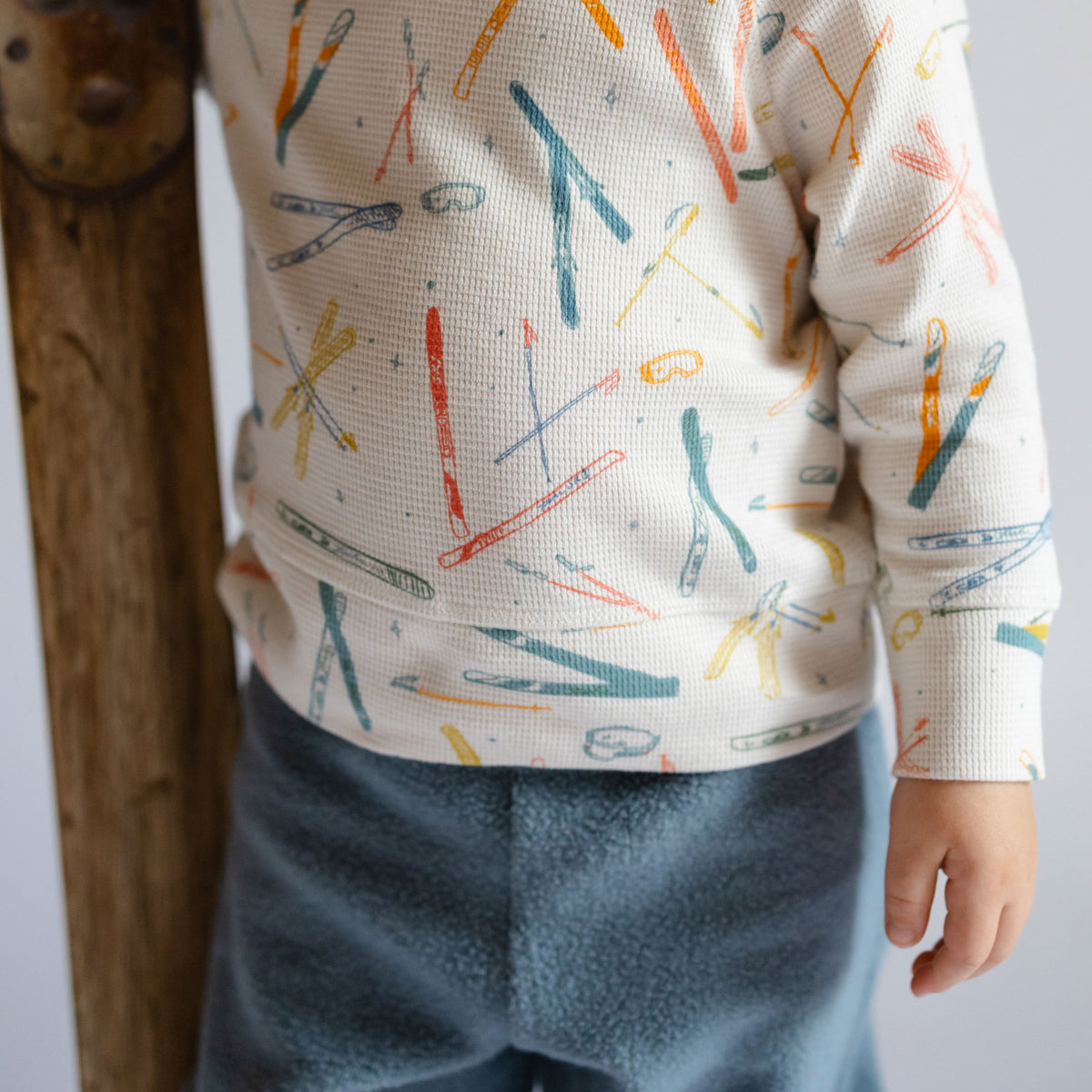 Petit Ski Long Sleeve Raglan Top - Apres- Up Close on Toddler- Colorful Ski Print