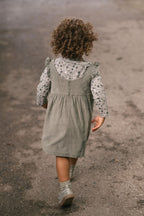corduroy pinafore dress sage in greens pattern on model back