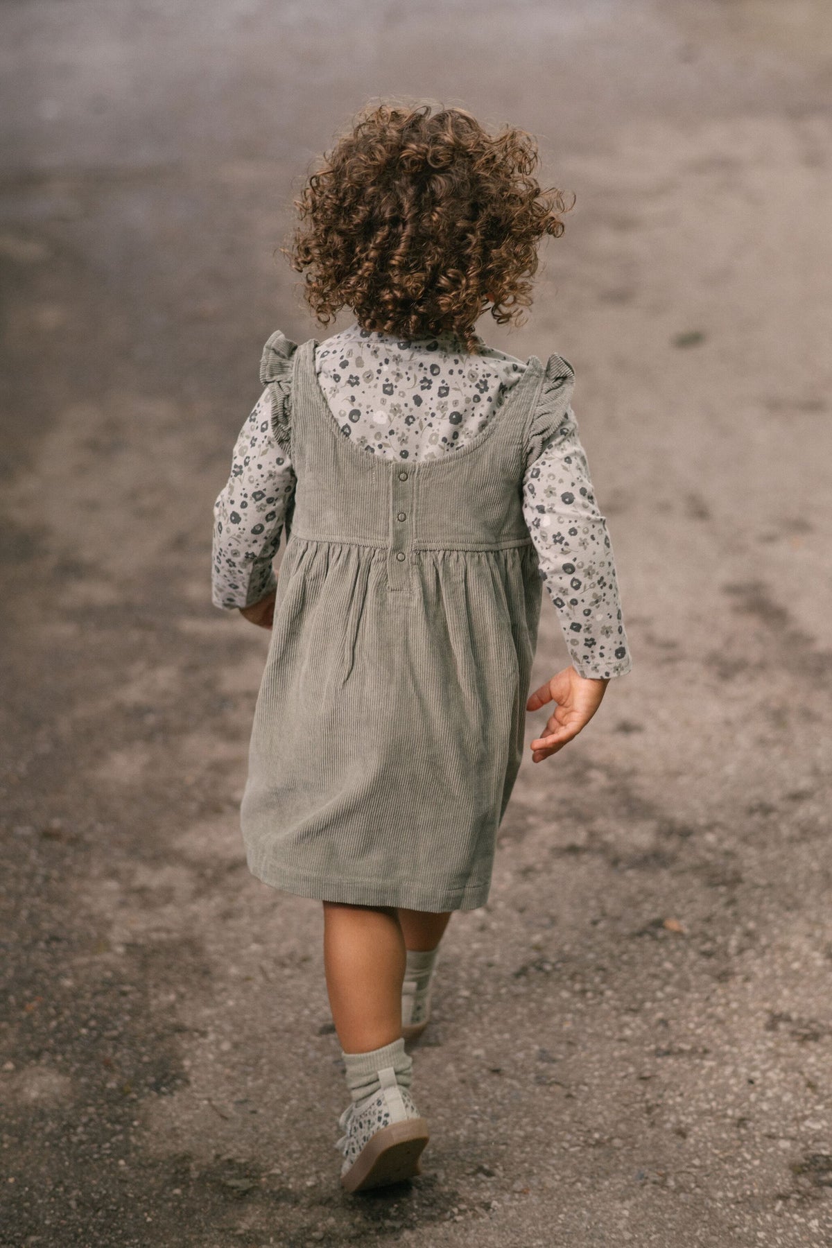 corduroy pinafore dress sage in greens pattern on model back