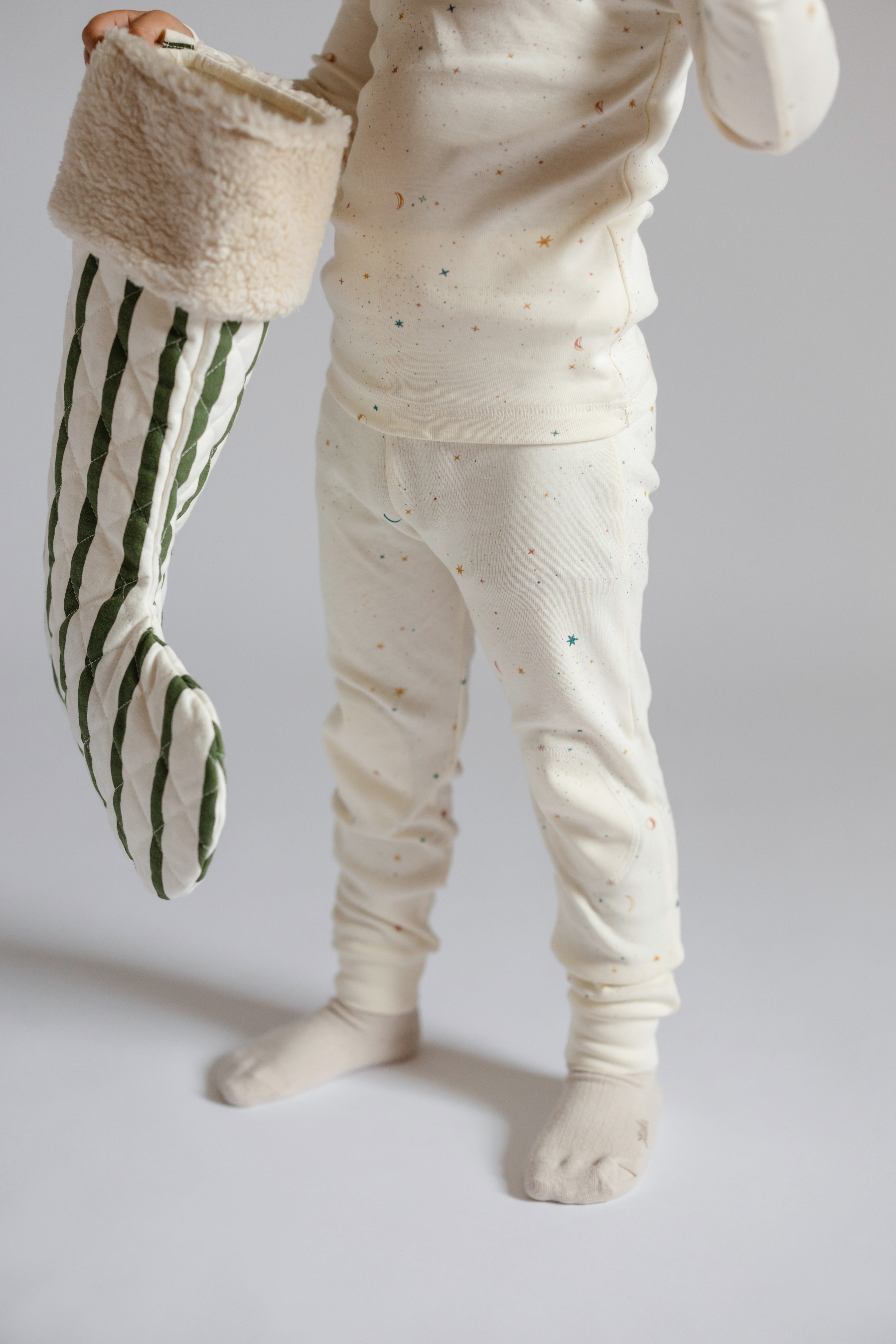Holiday Stocking - Juniper- Toddler Holding Green Striped Stocking