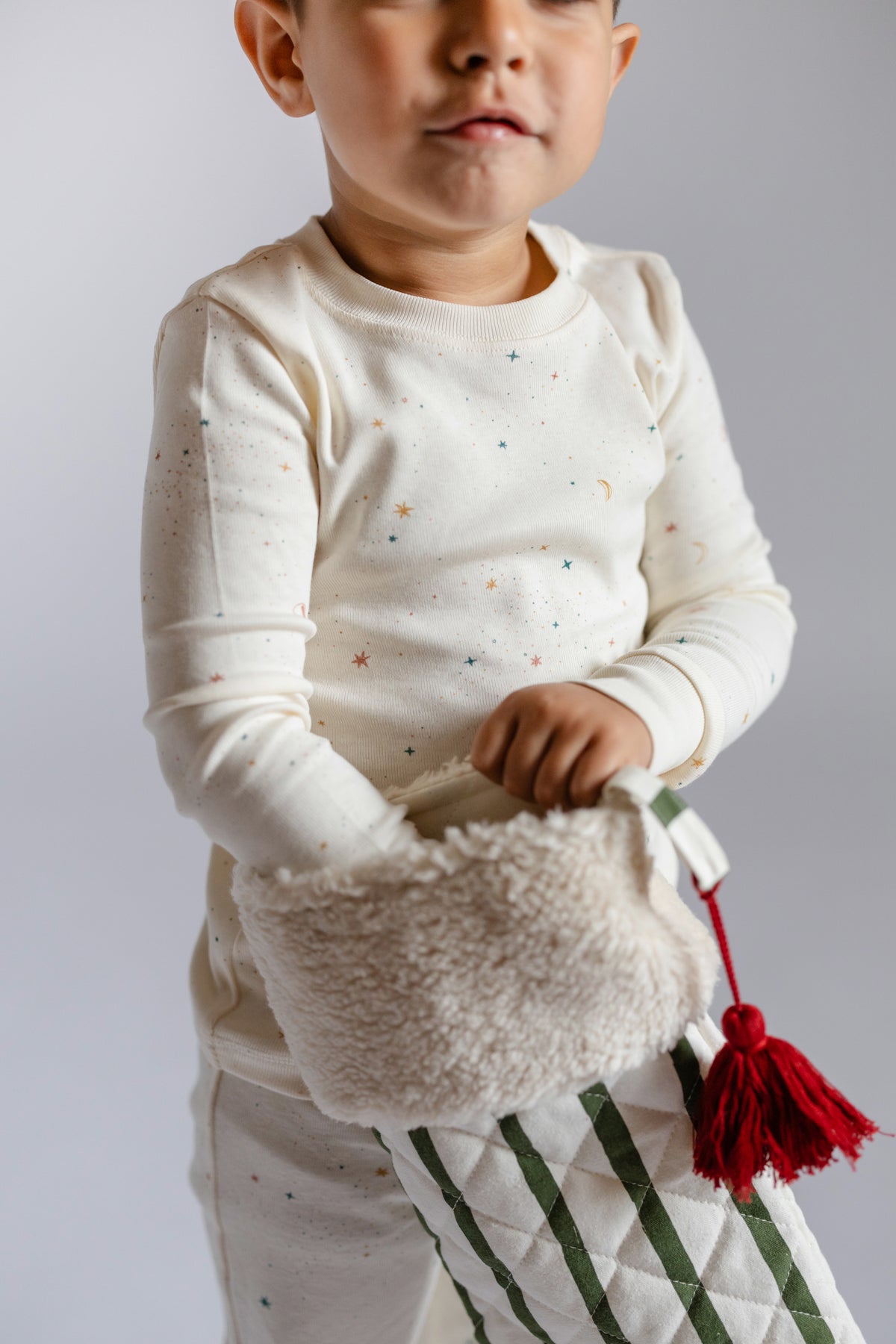 Holiday Stocking - Juniper- Toddler Holding Green Striped Stocking