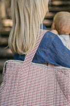 Gingham Convertible Diaper Bag - Mulberry- On Model Shoulder- Carrying Baby
